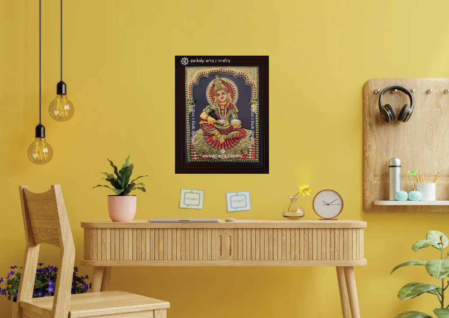 A framed 3D Annapoorni Tanjore painting displayed as a wall hanging, radiating depth and spirituality with intricate embossing, layered gold accents, and traditional craftsmanship.