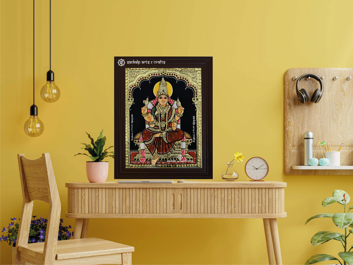A framed Ambal Tanjore painting displayed as a wall hanging, radiating divine energy with its detailed gold accents and vibrant hues, making it a striking focal point in any space.
