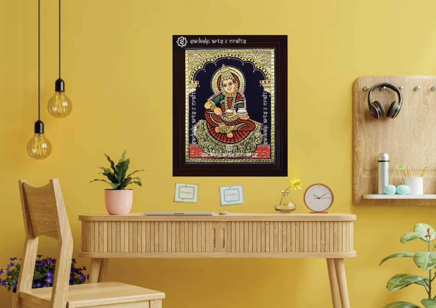 A framed Annapoorni Tanjore painting displayed as a wall hanging, radiating divine abundance with its intricate artwork, traditional gold accents, and spiritual presence.