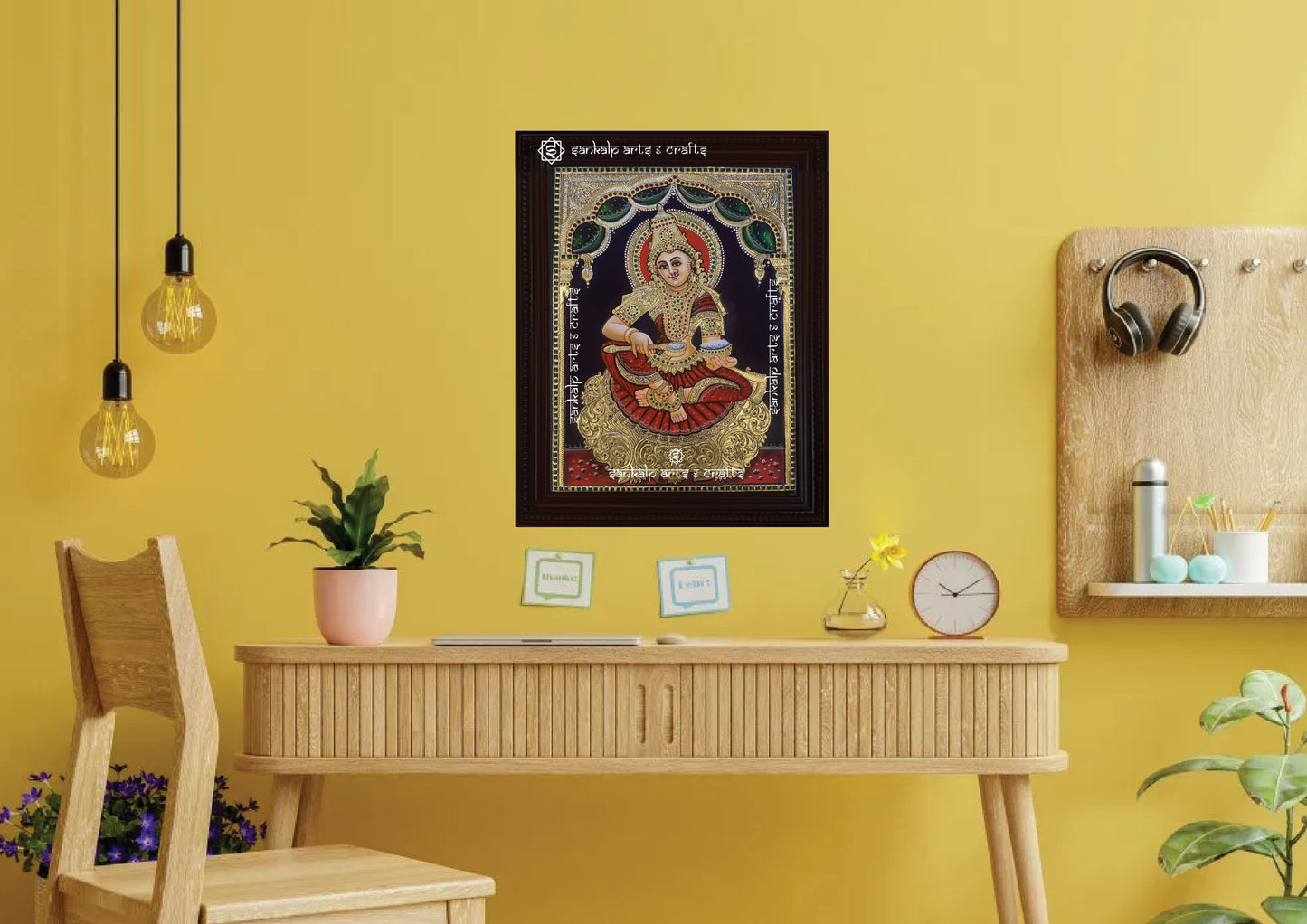 A framed Annapoorni Tanjore painting displayed as a wall hanging, radiating divine grace with intricate gold accents, vibrant colors, and a spiritually uplifting presence.