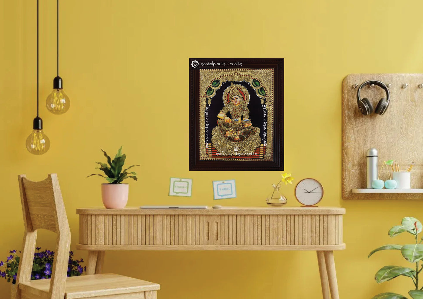 A framed Annapoorni Tanjore painting displayed as a wall hanging, radiating divine energy with its intricate gold work, vibrant colors, and spiritual significance.
