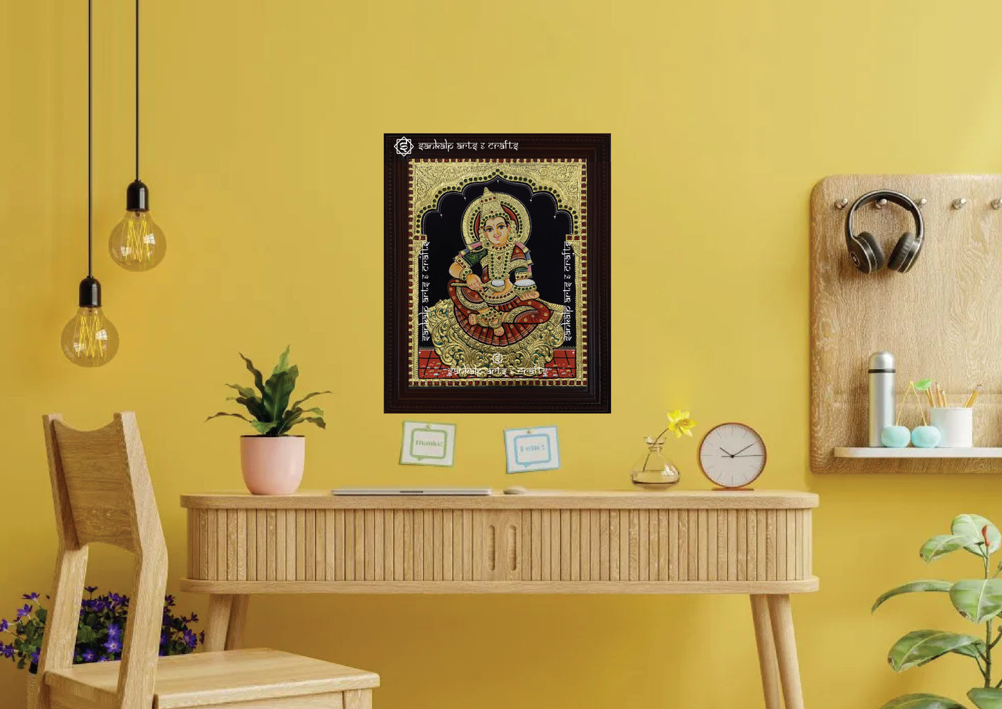 A framed Annapoorni Tanjore painting from Chennai displayed as a wall hanging, radiating divine energy with its intricate gold work and vibrant depiction of the goddess.