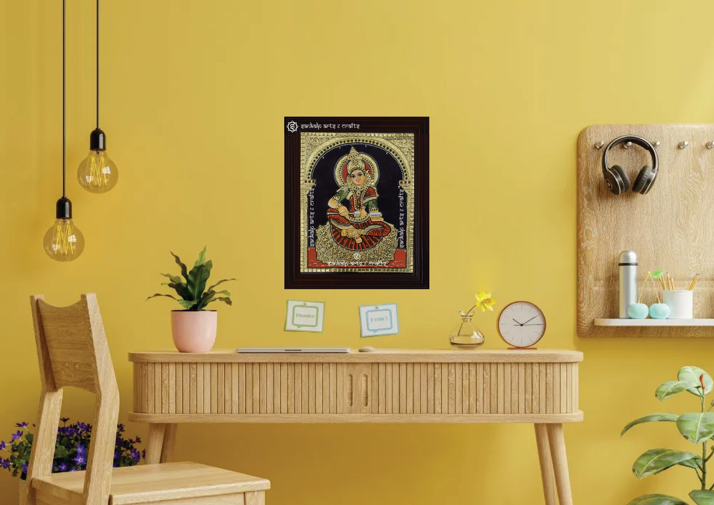 A framed Annapoorni Tanjore painting from Chennai, featuring the goddess in a traditional red saree, exuding divine grace with exquisite gold work and vibrant detailing.