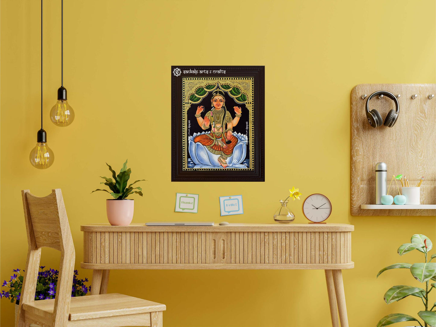A framed Bala Tripura Sundari Tanjore painting displayed as a wall hanging, showcasing stunning artistry with traditional gold foil work, perfect for enriching any room's ambiance.