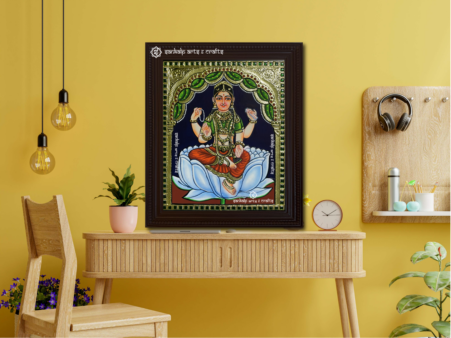 A framed Bala Tripura Sundari Tanjore painting displayed as a wall hanging, radiating divine grace with intricate artistry, traditional gold embellishments, and vibrant hues.