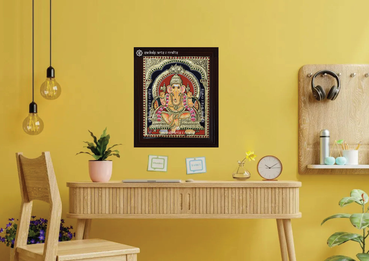 A framed Ganesha Tanjore painting, elegantly crafted with gold work and vibrant colors, perfect for bringing prosperity, blessings, and spiritual elegance to your pooja room or living space.