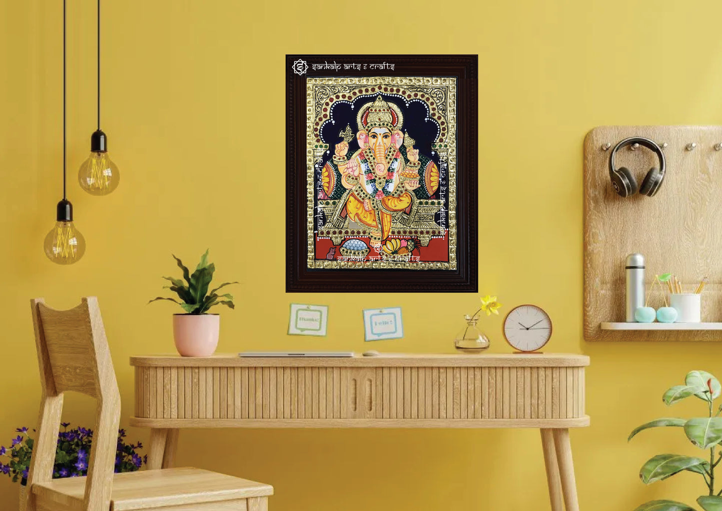 A framed Ganesha Tanjore painting, exquisitely designed with gold foil and vibrant hues, perfect for bringing positivity, prosperity, and divine grace to your pooja room or home décor.