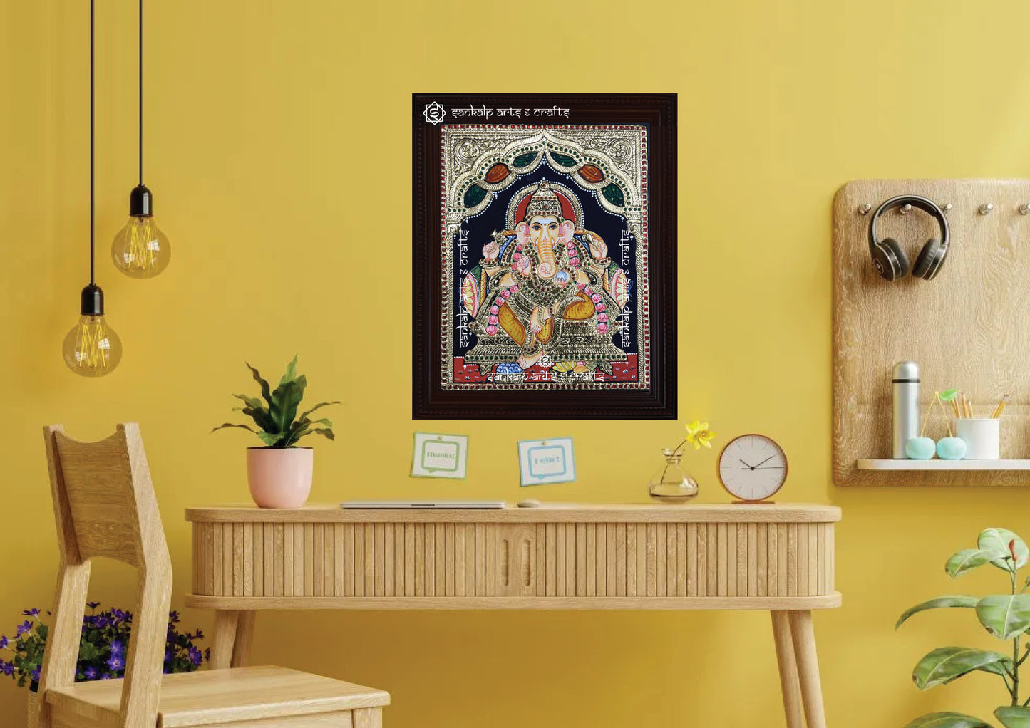 A framed Ganesha Tanjore painting, exquisitely crafted with gold foil and vibrant colors, perfect for enhancing your pooja room or home with positivity, prosperity, and divine grace.