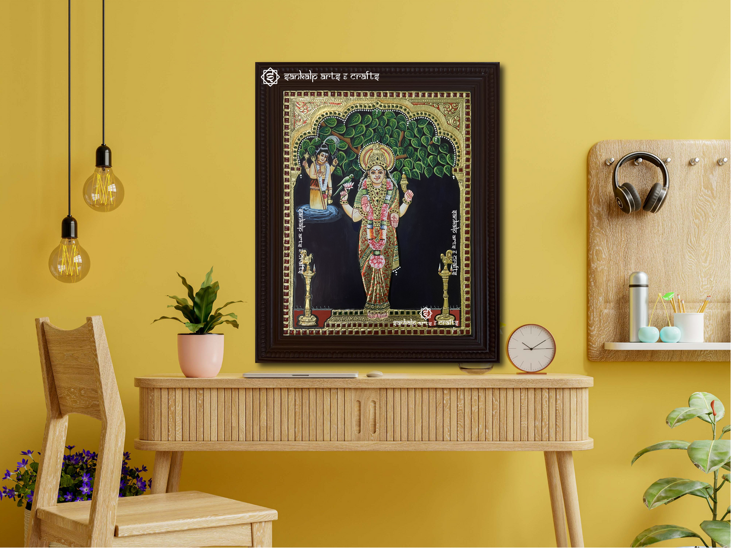 A framed Kanyaka Parameswari Tanjore painting displayed as a wall hanging, radiating divine energy with its intricate gold details and exquisite craftsmanship.