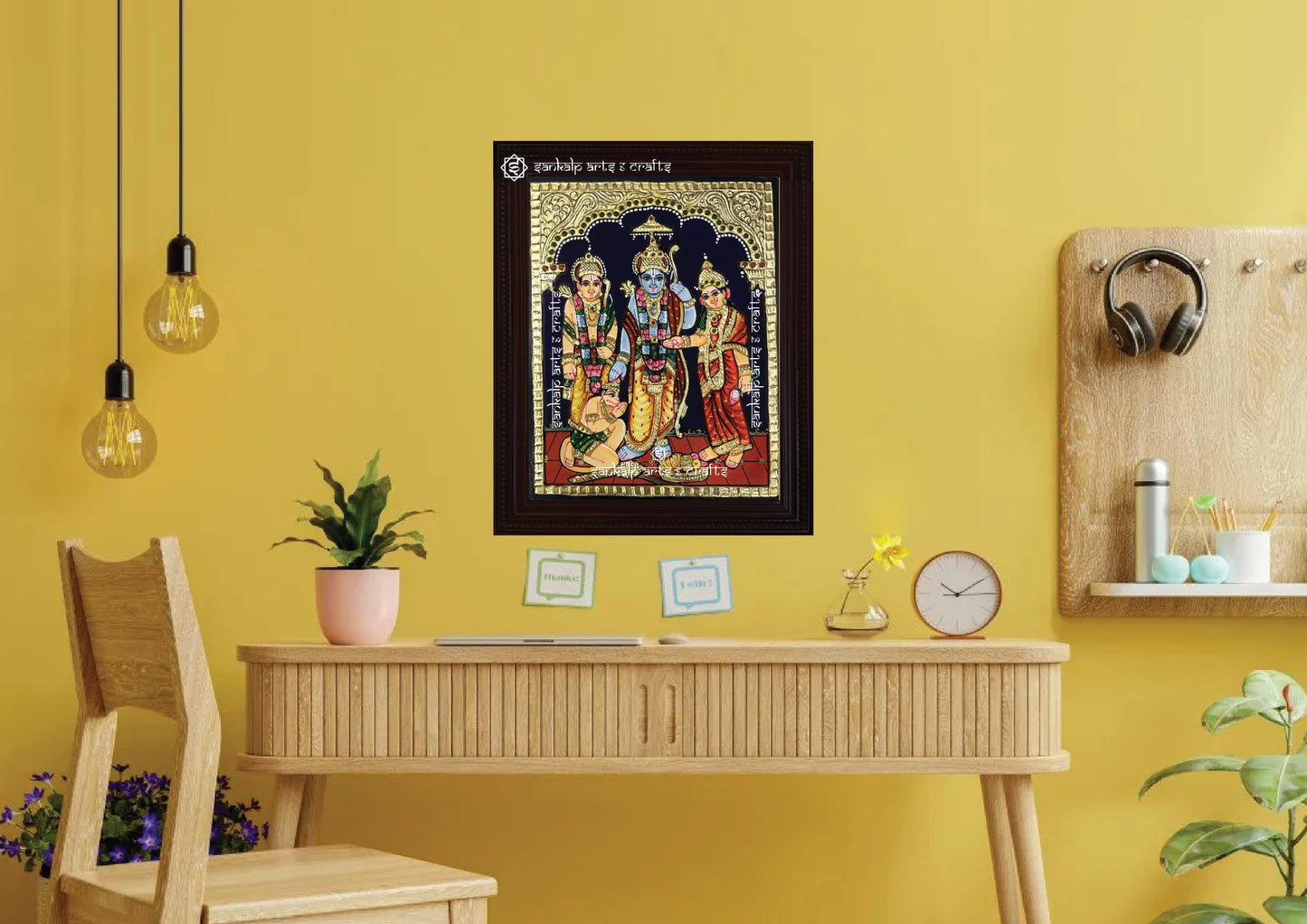 A framed Kodantha Ramar Tanjore painting, intricately designed with gold foil and vibrant colors, perfect for adding a divine touch of spirituality and protection to your pooja room or living space.