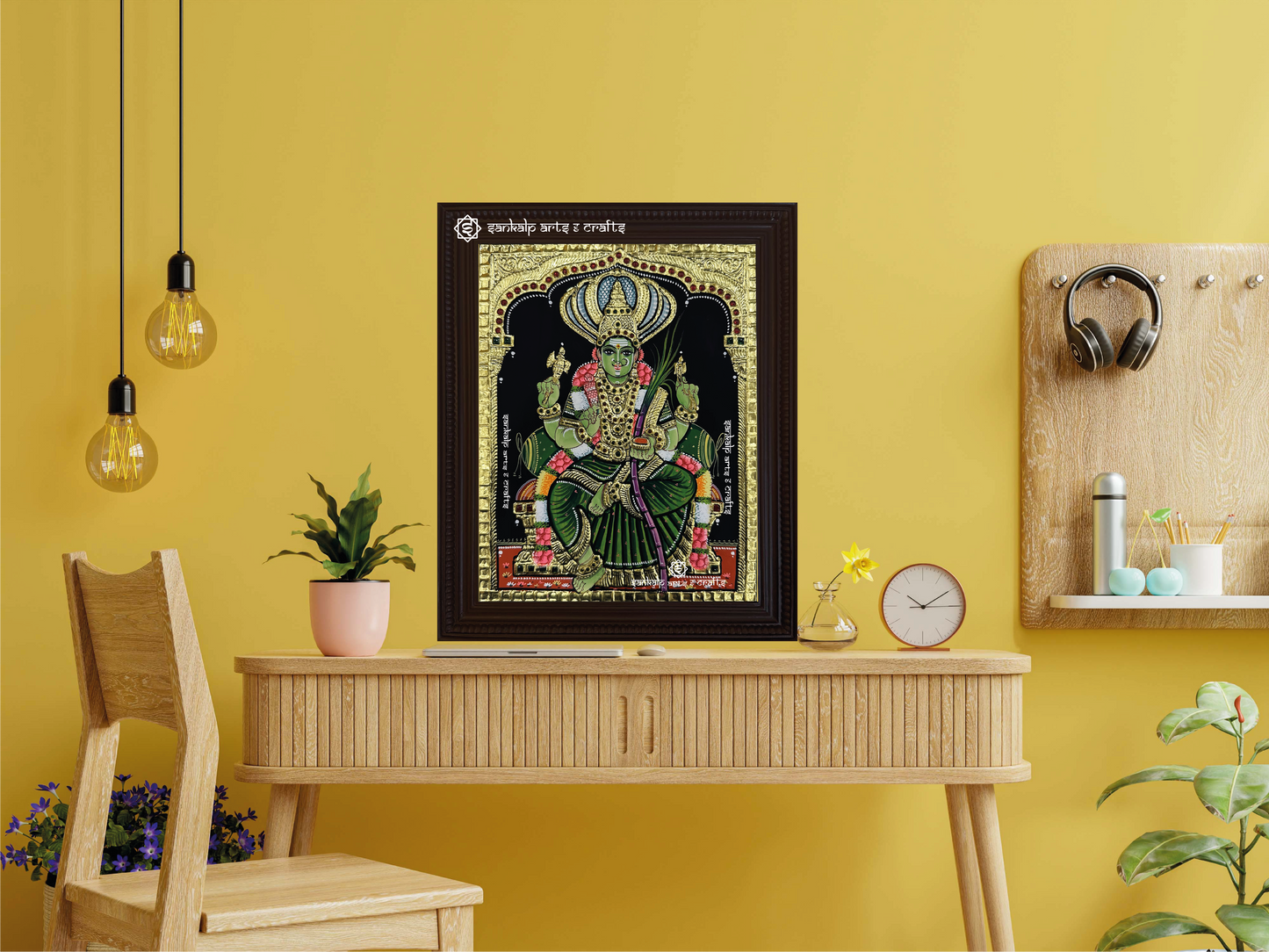 A framed Pachaiamman Tanjore painting displayed as a wall hanging, enhancing the room's ambiance with its divine energy, intricate gold details, and vibrant hues.