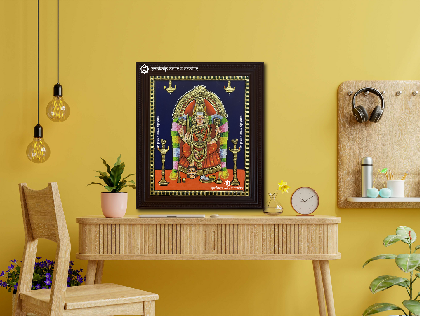 A framed Samayapuram Mari Amman Tanjore painting displayed as a wall hanging, radiating spiritual energy with its intricate gold work and traditional artistic detailing.