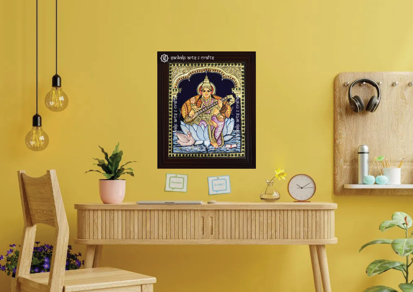 A framed Saraswathi Tanjore painting, intricately designed with gold foil and vibrant colors, perfect for adding a divine touch and spiritual elegance to your pooja room, living space, or study area.