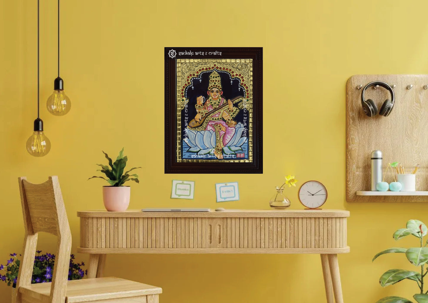 A framed Saraswathi Tanjore painting, radiating divine energy with intricate gold work, vibrant hues, and spiritual symbolism, perfect for enhancing the pooja room or living space with wisdom and peace.