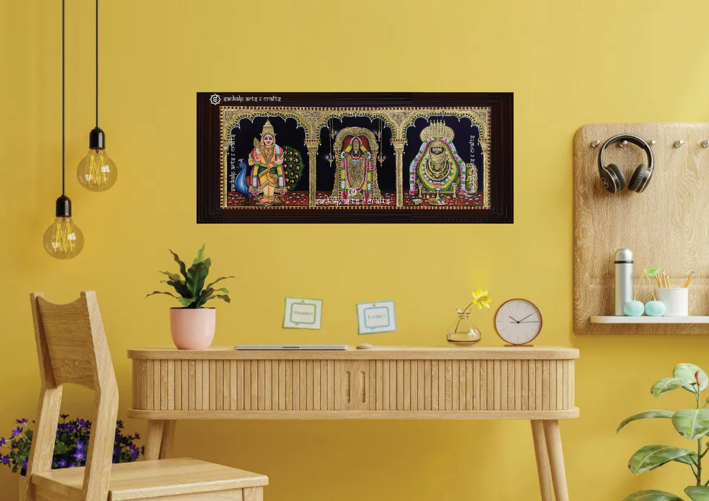 A framed custom Tanjore painting designed for wall hanging, featuring divine figures with intricate gold detailing. This personalized artwork is perfect for enhancing the spiritual atmosphere of your pooja room.