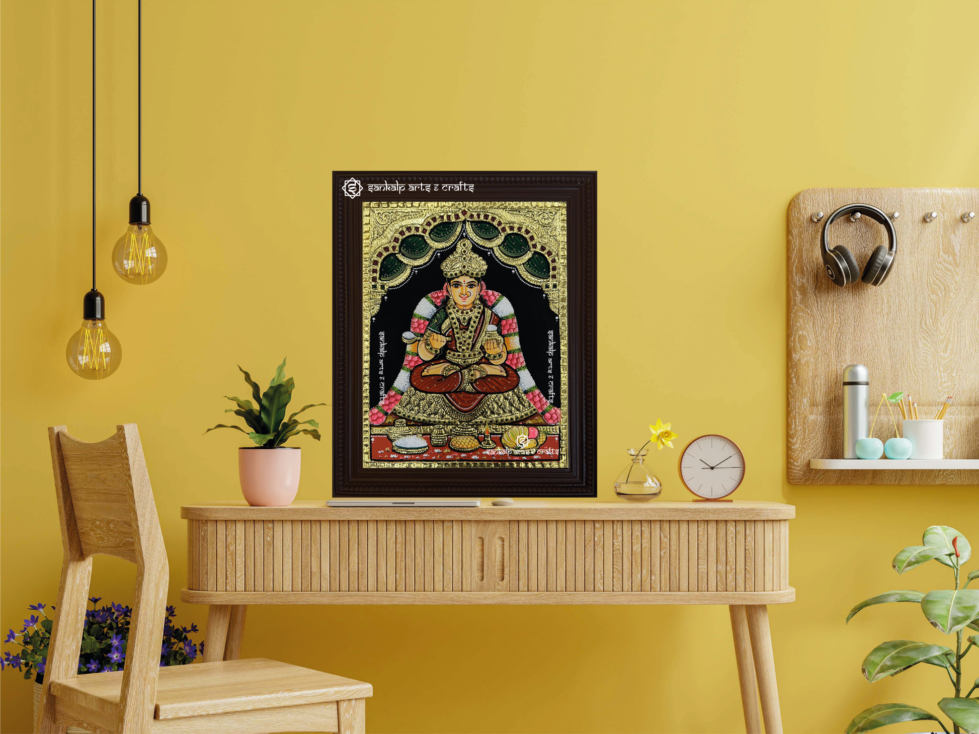 A framed Annapoorani Tanjore painting displaying the goddess in a maroon saree, radiating divine grace with intricate gold work, vibrant hues, and spiritual significance.







