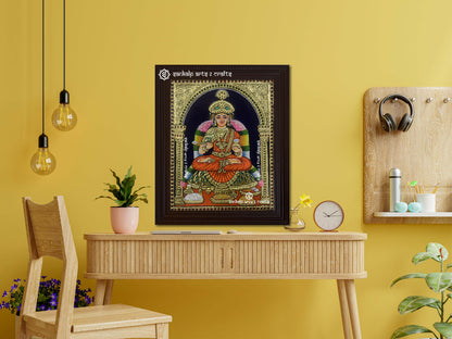 A framed Annapoorani Tanjore painting displaying the goddess in an orange saree, radiating divine grace with intricate gold work, vibrant hues, and spiritual energy.







