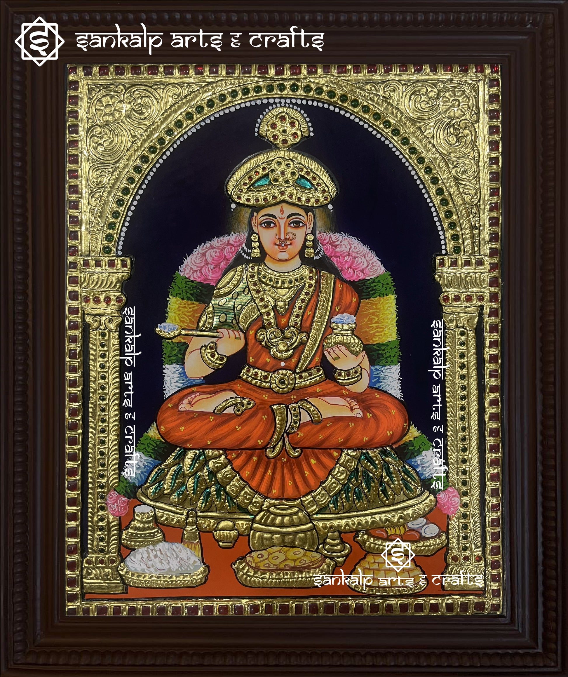 A divine Annapoorani Tanjore painting featuring the goddess of nourishment, gracefully adorned in an orange saree with intricate gold foil detailing and vibrant traditional colors.

