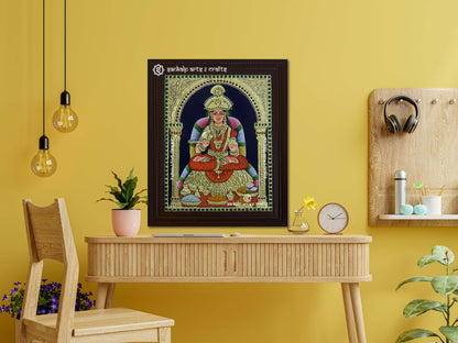 A framed Annapoorani Tanjore painting displayed as a wall hanging, radiating divine grace with vibrant hues, gold accents, and intricate artistic detailing.








