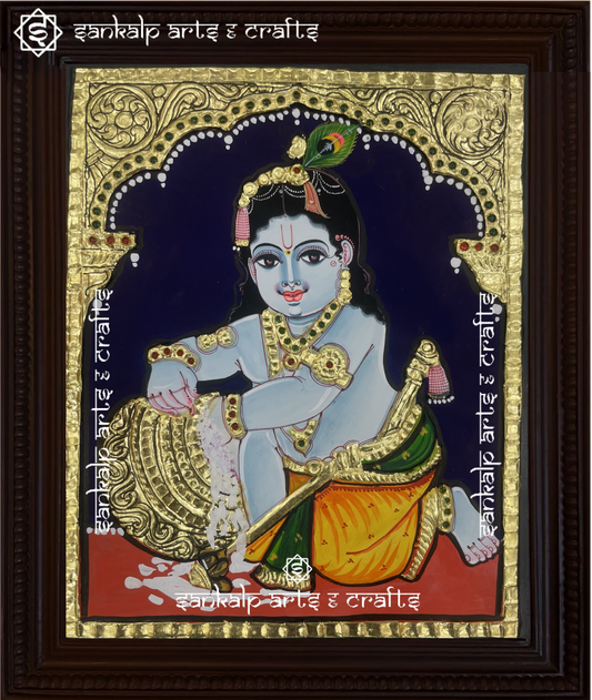 A stunning Tanjore painting of Butter Krishna, handcrafted with rich gold foil detailing, perfect for home decor in Chennai & Bangalore.

