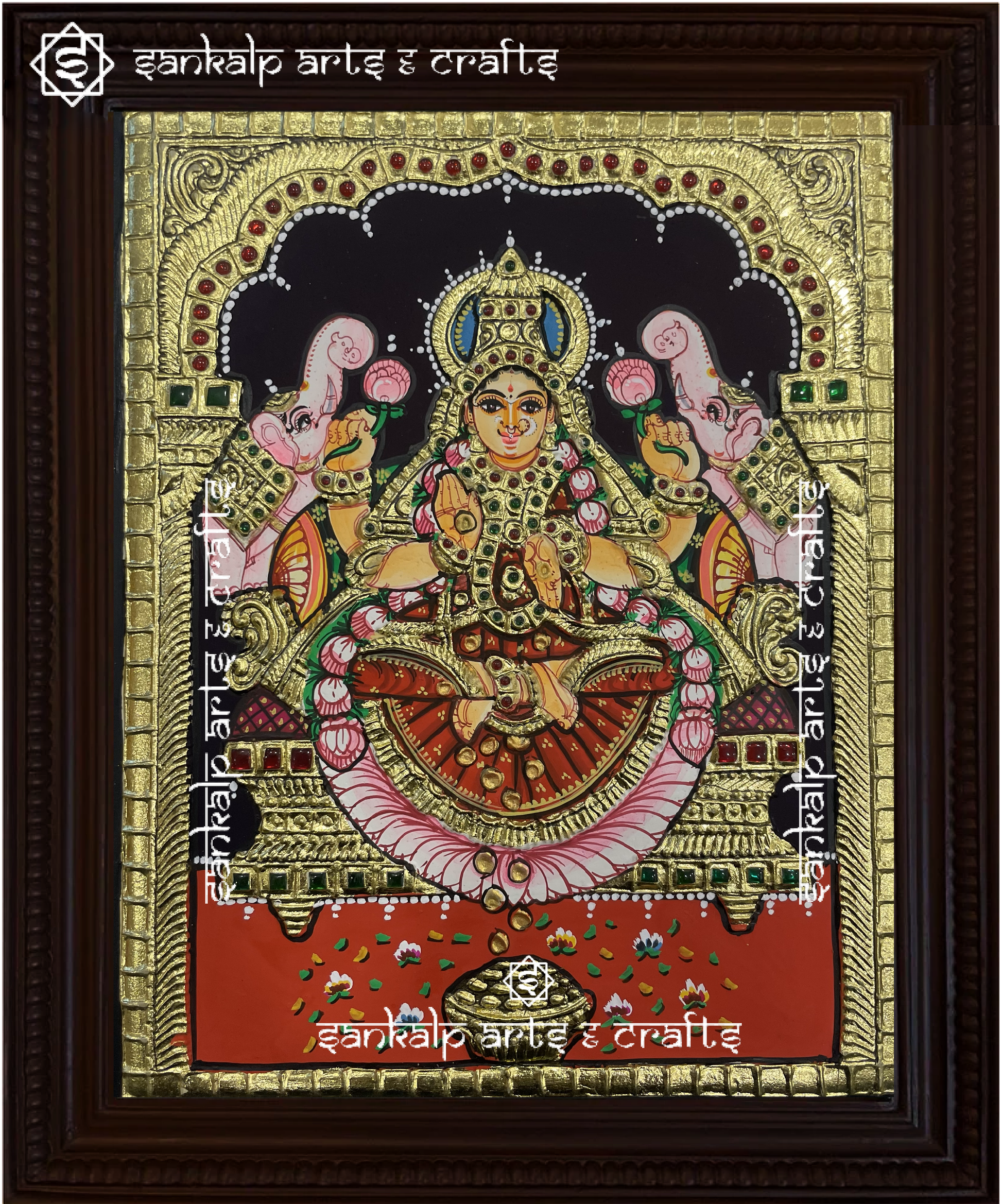 A beautifully framed Tanjore painting of Goddess Gajalakshmi, seated on a lotus with elephants showering blessings. A perfect decor piece for homes in Chennai & Bangalore.