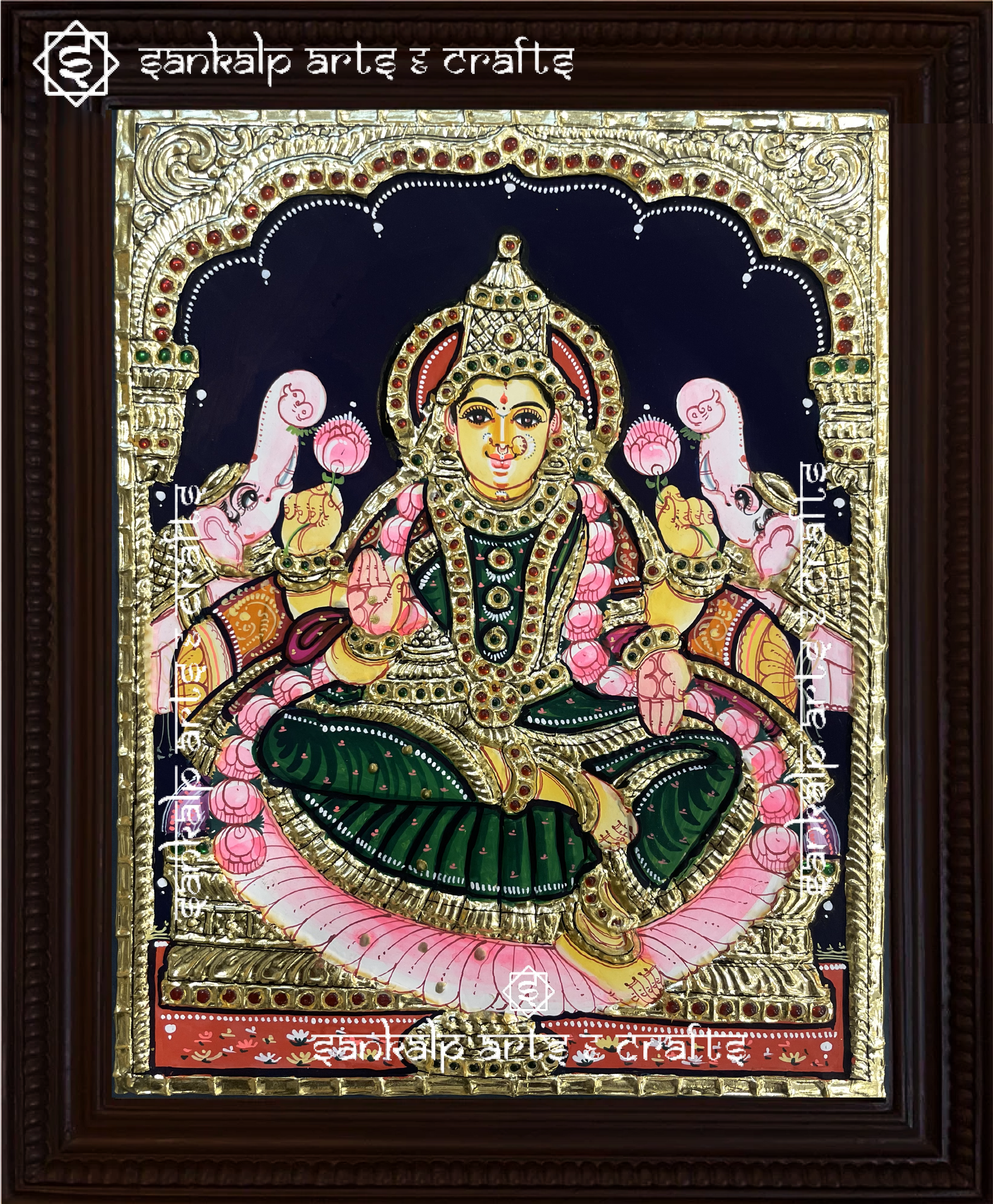 A beautifully handcrafted Gajalakshmi Tanjore painting showcasing Goddess Lakshmi seated on a lotus, flanked by two elephants showering blessings. The intricate gold foil detailing and vibrant colors enhance the divine aura of the artwork.


