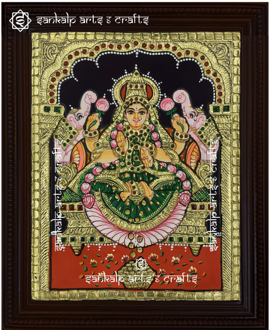 A beautifully handcrafted Gajalakshmi Tanjore painting depicting Goddess Lakshmi with two elephants, symbolizing wealth, prosperity, and abundance, adorned with intricate gold foil detailing and vibrant colors.

