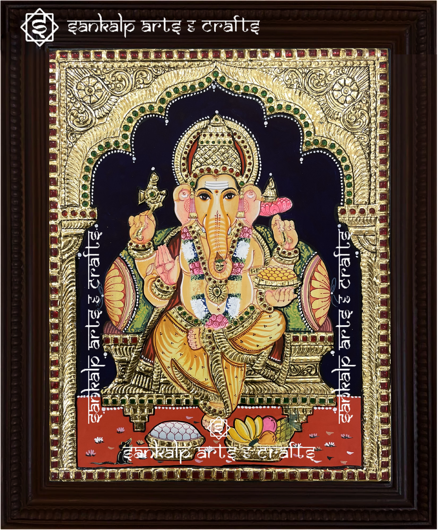 A close-up of the Ganesha Tanjore painting showcasing Lord Ganesha holding his sacred symbols, embellished with gold detailing and rich hues, symbolizing wisdom, prosperity, and success.


