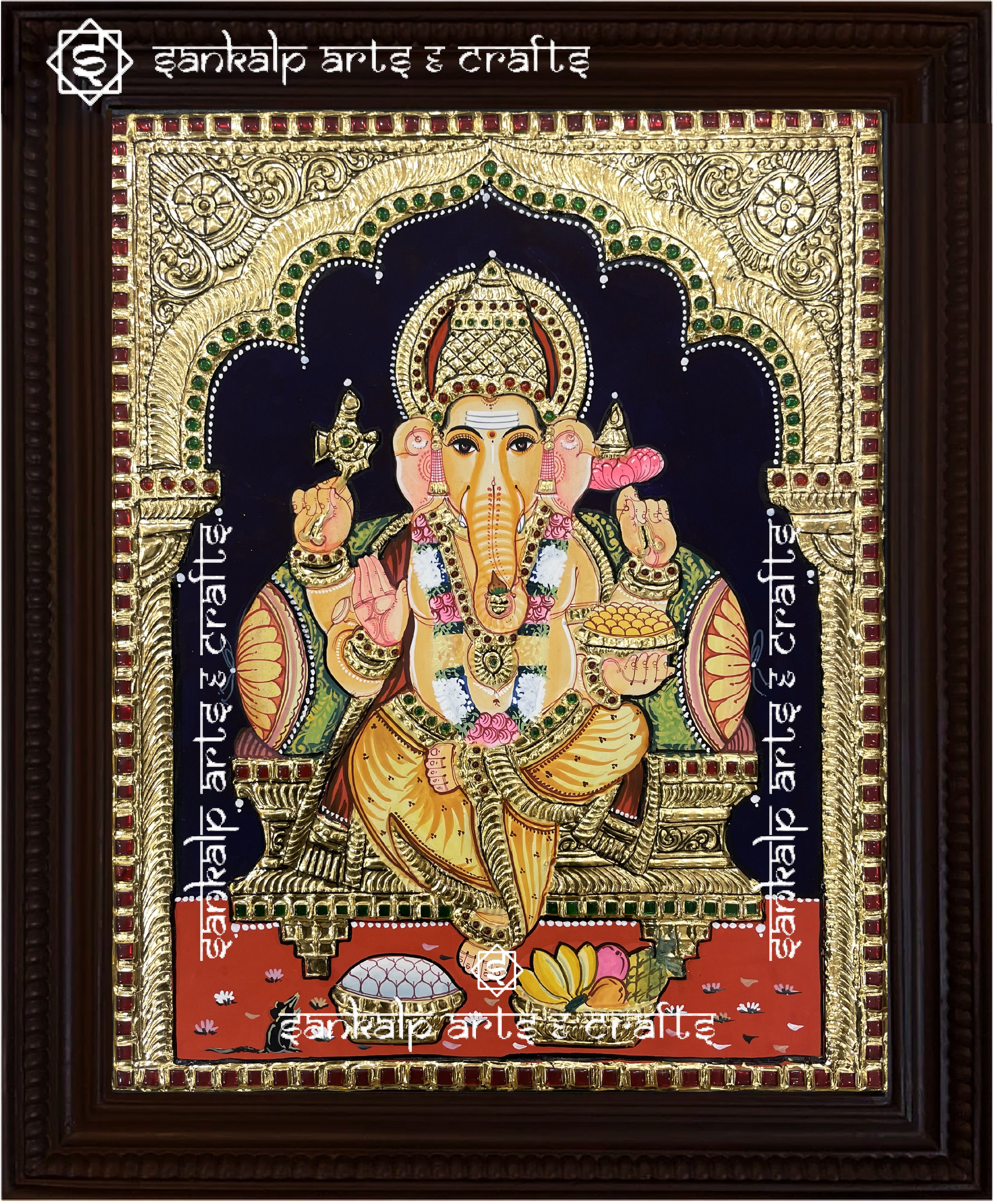 A close-up of the Ganesha Tanjore painting showcasing Lord Ganesha holding his sacred symbols, embellished with gold detailing and rich hues, symbolizing wisdom, prosperity, and success.


