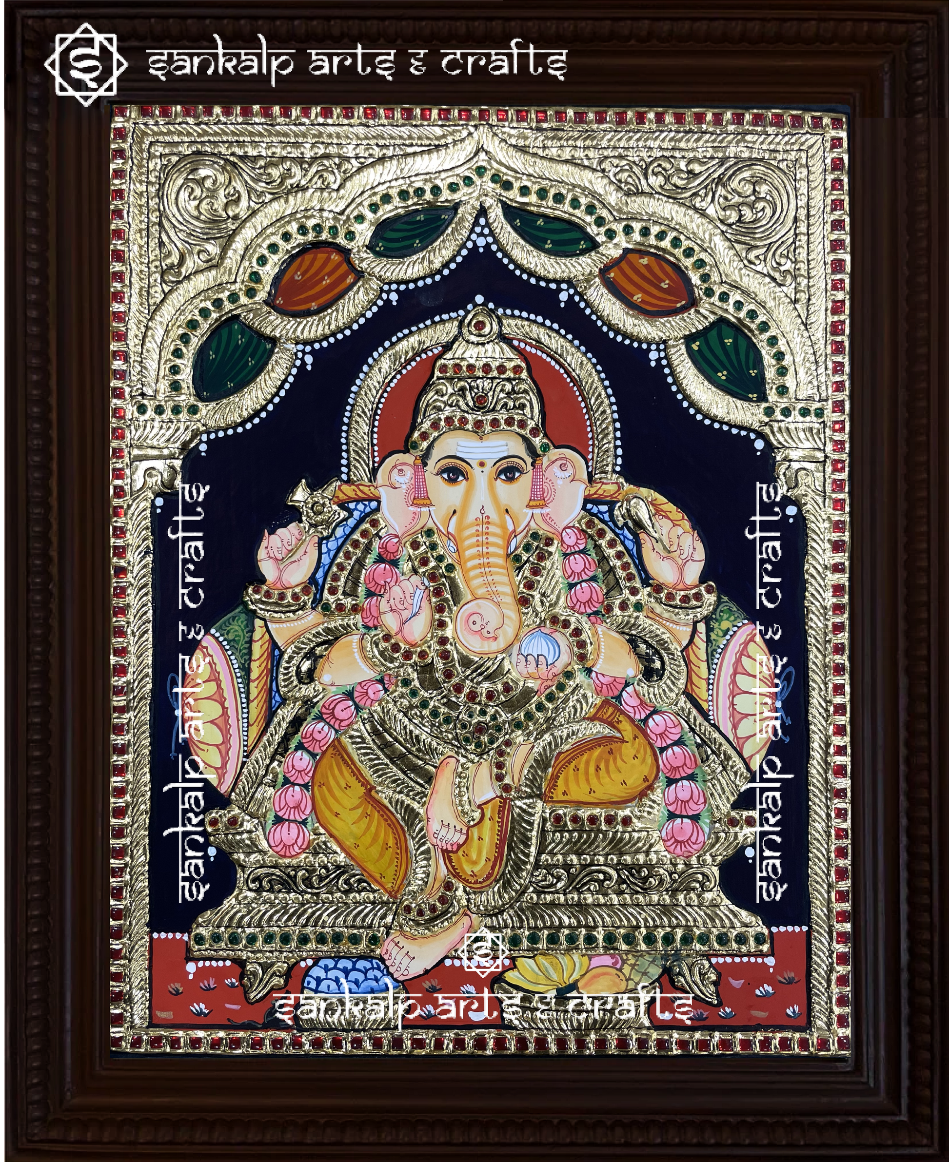 A close-up of the Ganesha Tanjore painting, showcasing the deity in a majestic pose with rich gold foil work, intricate embellishments, and divine aura, representing success, wisdom, and protection.

