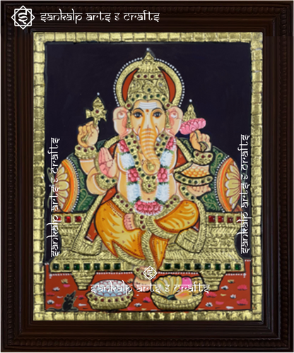 A beautifully framed Tanjore painting of Lord Ganesha, adorned with intricate gold foil and rich colors. A perfect decor piece for homes in Chennai & Bangalore.