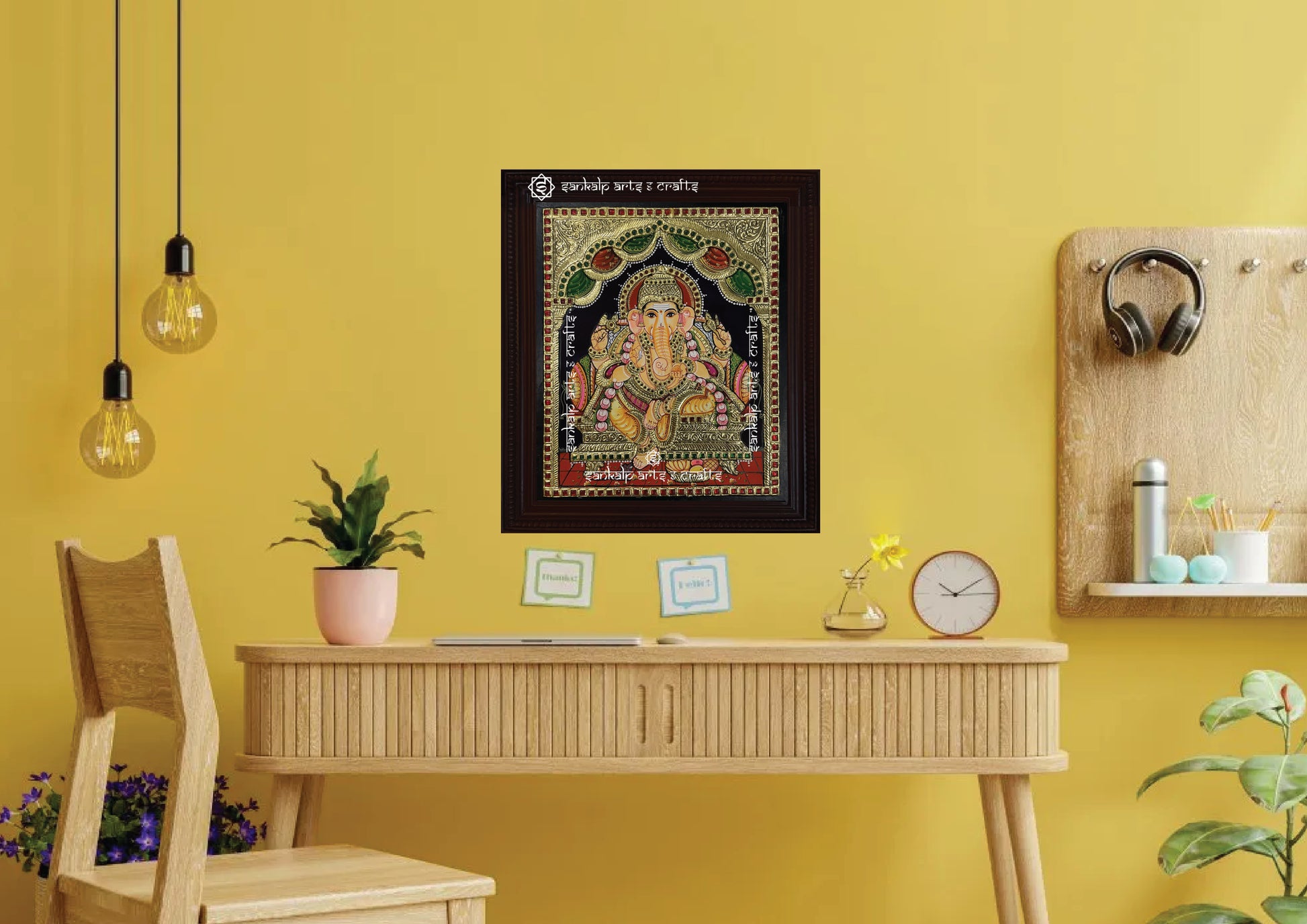 A framed Ganesha Tanjore painting, featuring exquisite gold foil detailing and vibrant colors, ideal for enhancing the spiritual ambiance of your pooja room or living space with divine blessings.

