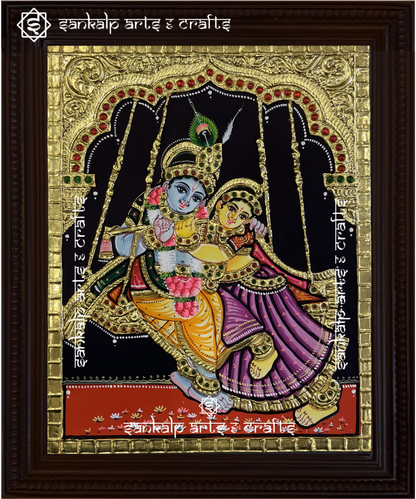 This North Indian-style Radha Krishna Tanjore painting captures the divine couple on a swing, exuding grace and beauty. A perfect addition to Chennai & Bangalore homes.