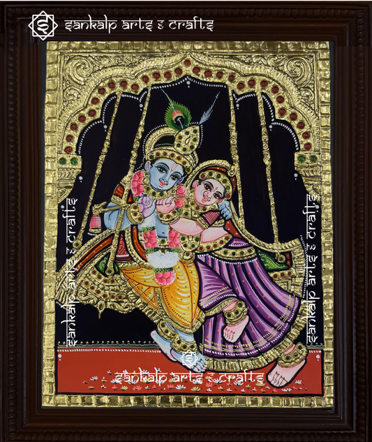 A divine Jhula Radha Krishna Tanjore painting in North Indian style, featuring Krishna and Radha on a beautifully decorated swing. Handcrafted for homes in Chennai & Bangalore.