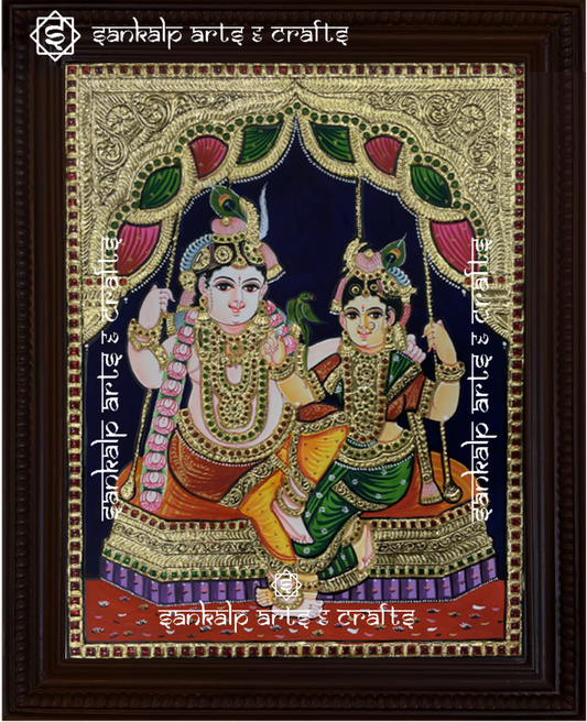 A beautifully handcrafted Jhula Radhe Krishna Tanjore painting in South Indian style, depicting Lord Krishna and Radha joyfully seated on a swing. The vibrant colors and intricate gold foil detailing enhance the divine beauty of this artwork.

