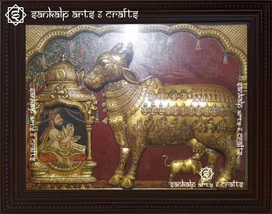 A stunning antique Kamadhenu Tanjore painting featuring the sacred wish-fulfilling cow, adorned with intricate gold foil detailing and traditional craftsmanship.

