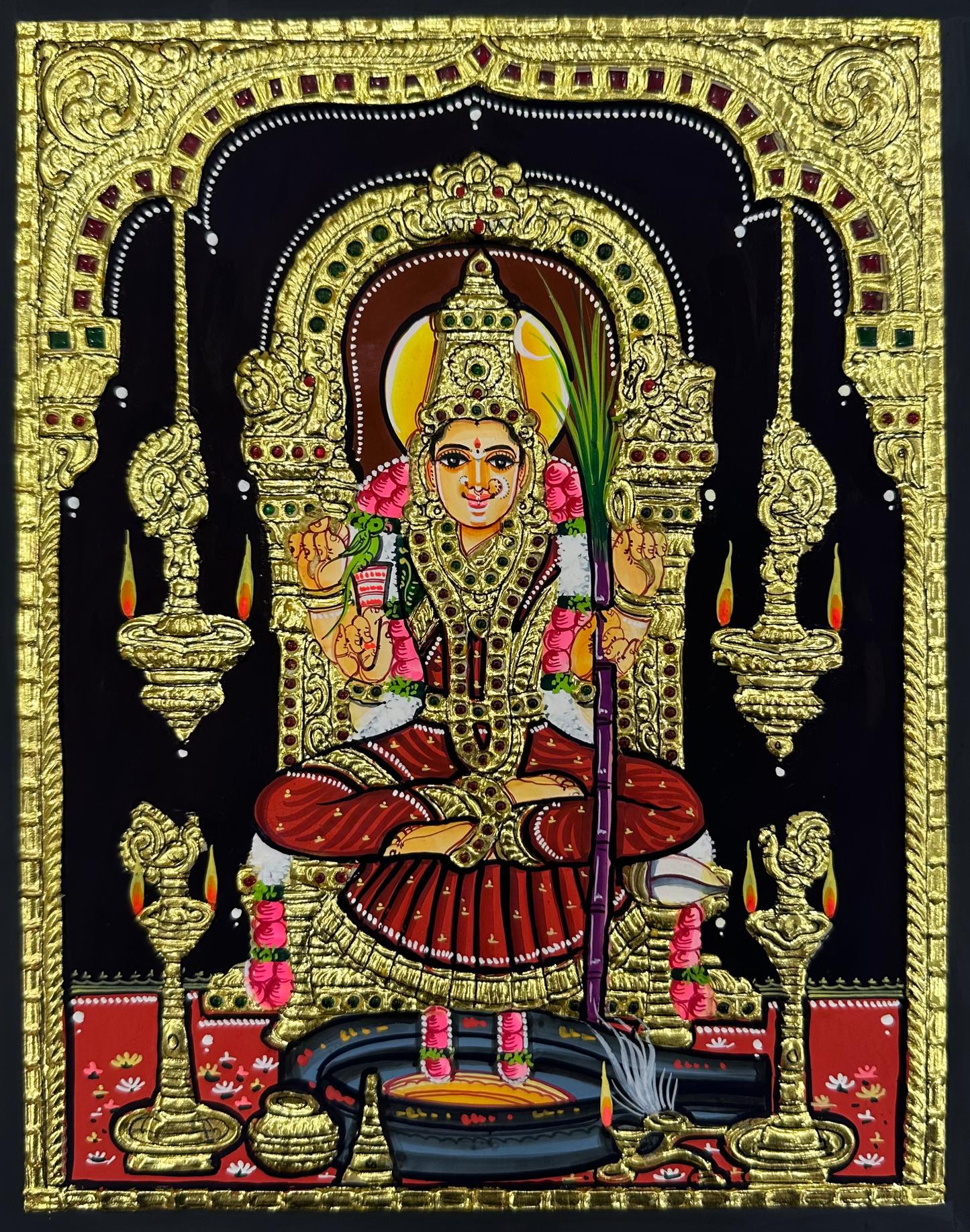 A close-up view of the Kamakshi Amman Tanjore painting, featuring rich textures and delicate gold accents, perfect for adding spiritual elegance to any room.

