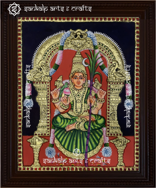 A beautifully framed Tanjore painting of Goddess Kamakshi Amman, crafted with intricate gold foil work. A perfect decor piece for homes in Chennai & Bangalore.