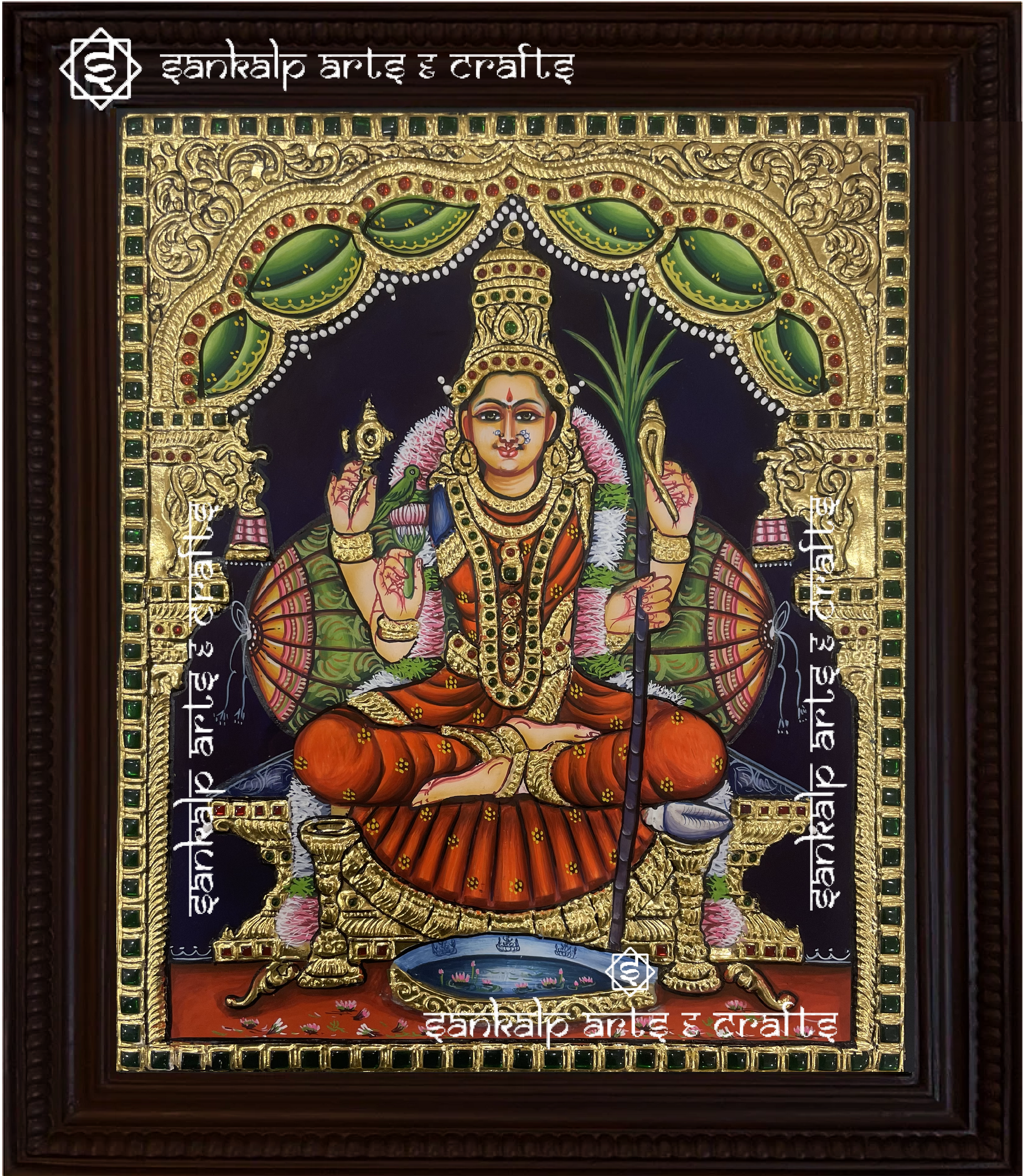 A beautifully framed Tanjore painting of Kamakshi Amman, adorned with intricate gold foil work. A perfect decor piece for homes in Chennai & Bangalore.