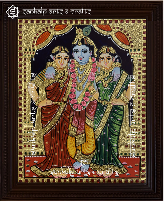A beautifully handcrafted Krishna Bama Rukmani Tanjore painting depicting Lord Krishna with his consorts, Bama and Rukmani, in a divine and playful scene. The intricate gold foil detailing and vibrant colors bring out the beauty and spiritual energy of the artwork.