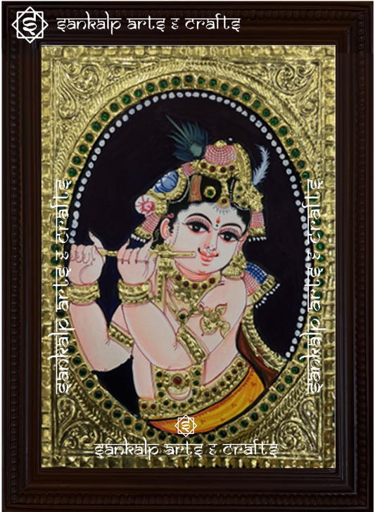 A beautifully handcrafted Krishna Tanjore painting depicting Lord Krishna in a divine pose, adorned with intricate gold foil detailing and vibrant colors, capturing his timeless grace and spirituality.


