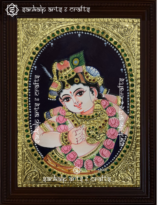A close-up of the Ladoo Krishna Tanjore painting showcasing Lord Krishna in his playful form, holding laddoos, with exquisite gold embellishments and vibrant hues, radiating divine joy and charm.

