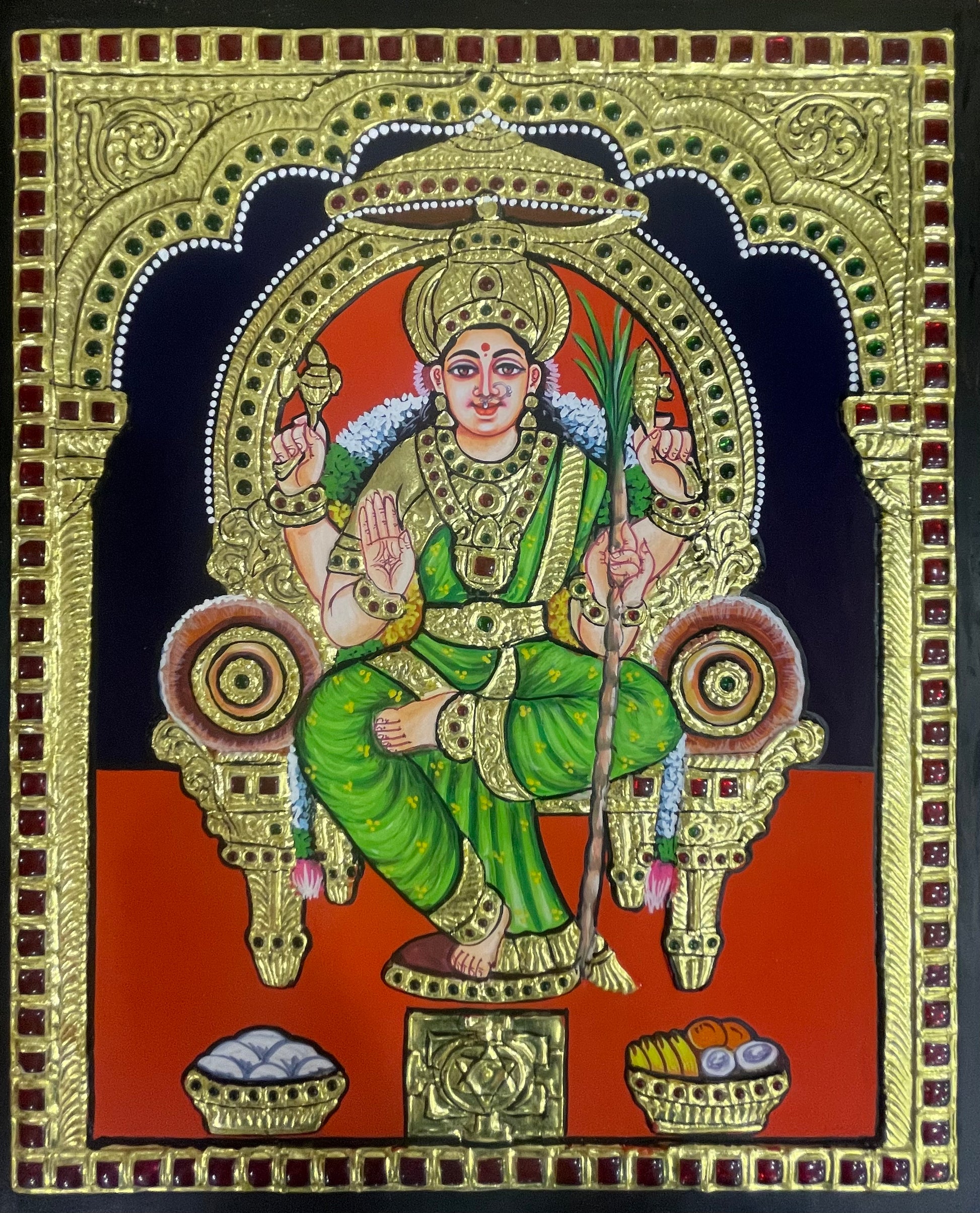 A close-up of the Lalitha Parameshwari Tanjore painting, highlighting the rich textures, gold embellishments, and the divine presence of the goddess holding her Chakram.