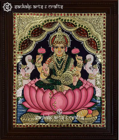 A beautifully handcrafted Mahalakshmi Tanjore painting depicting Goddess Lakshmi seated on a lotus, adorned with intricate gold foil detailing and vibrant colors. This masterpiece symbolizes wealth, prosperity, and divine blessings.

