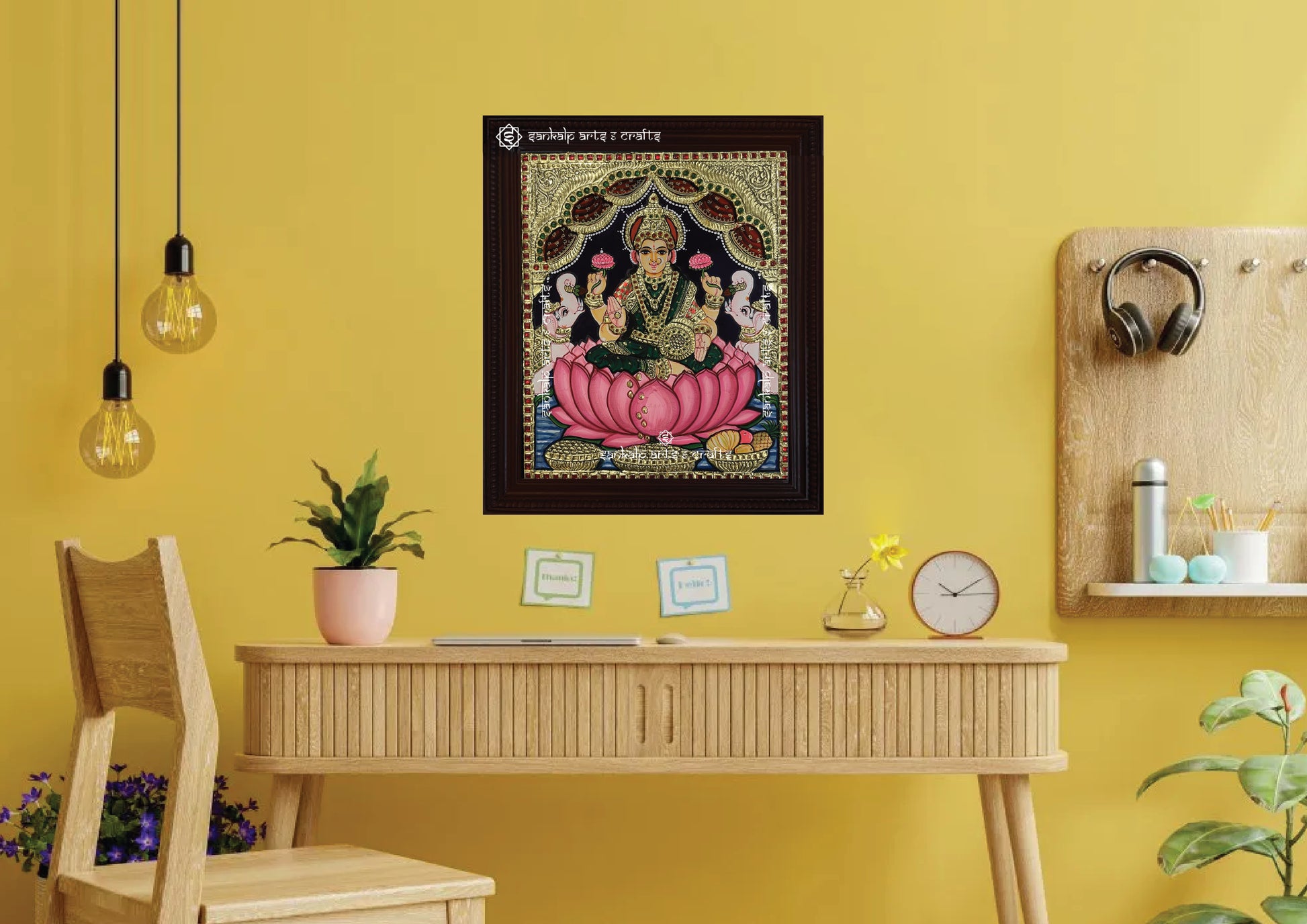 A framed Mahalakshmi Tanjore painting, featuring intricate gold foil detailing and vibrant colors, ideal for enhancing the spiritual ambiance of your pooja room or living space with divine energy and blessings.

