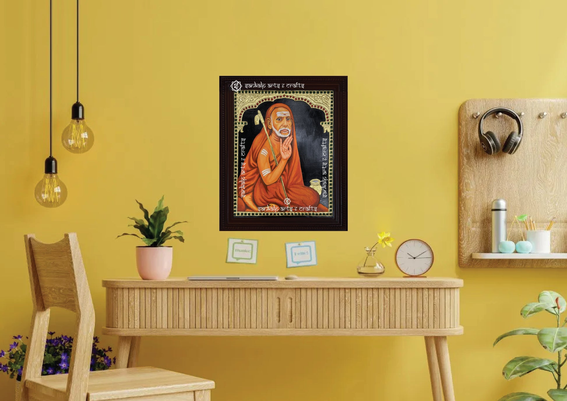 A framed Mahaperiyava Tanjore painting, intricately designed with gold foil and vibrant colors, perfect for bringing blessings, peace, and spiritual grace to your pooja room or living space.

