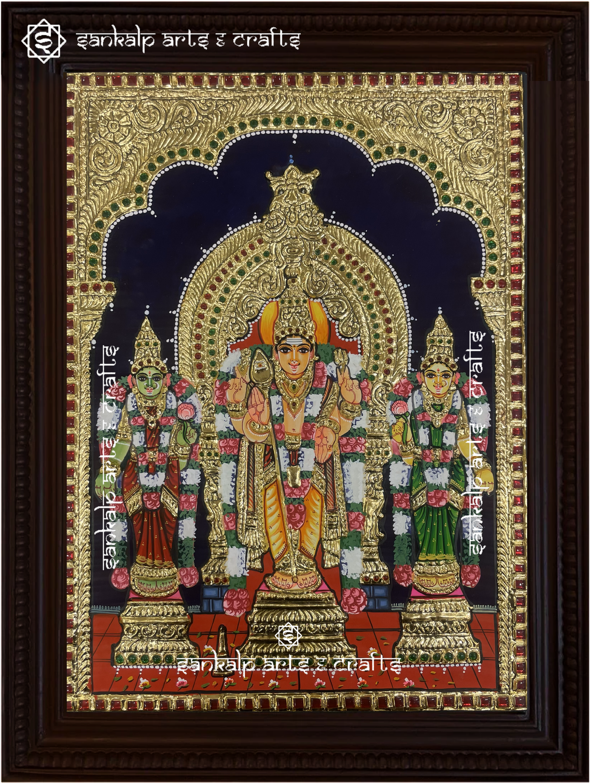 A stunning framed Tanjore painting of Lord Murugan with Goddess Valli and Deivanai, embellished with gold foil work. A perfect spiritual decor piece for homes in Chennai & Bangalore.

