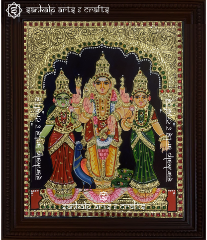 A beautifully framed Tanjore painting of Lord Murugan with Goddess Valli and Deivanai, adorned with rich gold foil work. A perfect spiritual decor piece for homes in Chennai & Bangalore.

