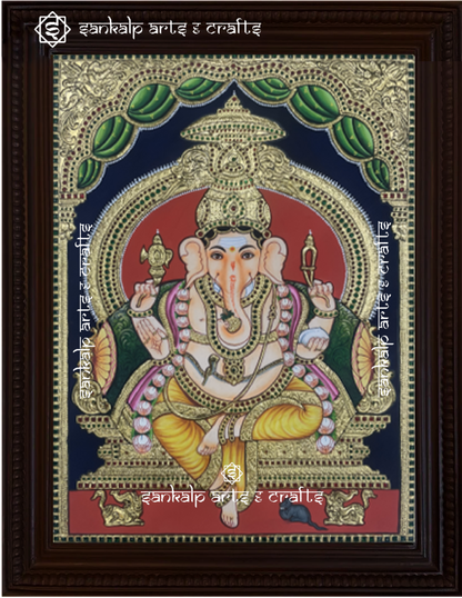 A beautifully framed Tanjore painting of Raja Alangara Ganesha, adorned with intricate gold foil work and rich colors. A perfect decor piece for homes in Chennai & Bangalore.