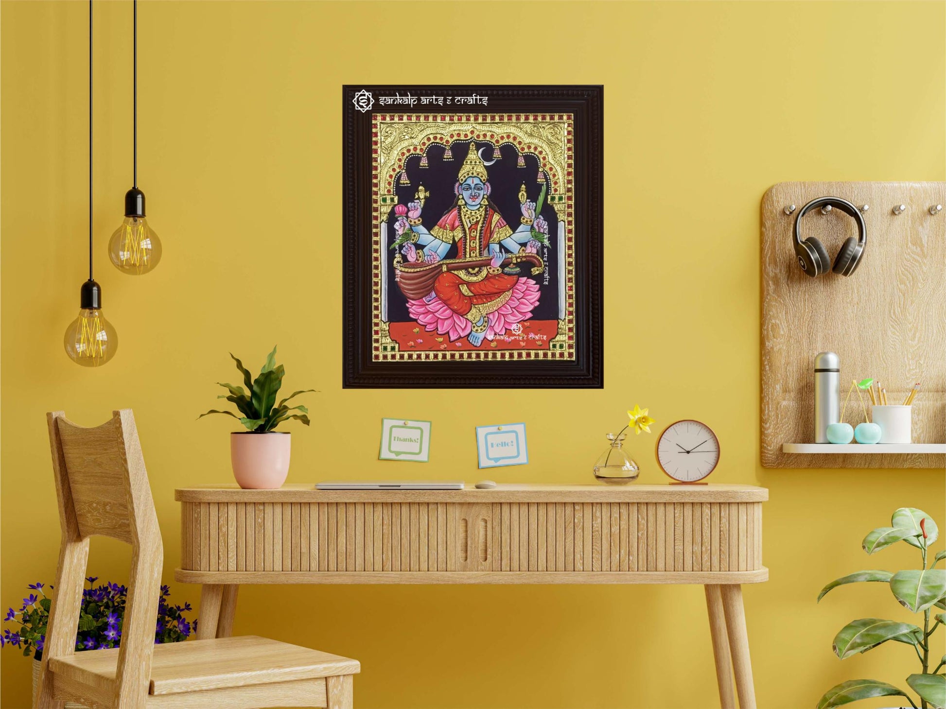 A framed Rajashamala Devi Tanjore painting, displayed as a wall hanging, showcasing rich textures and gold work that elevate the beauty of any room.







